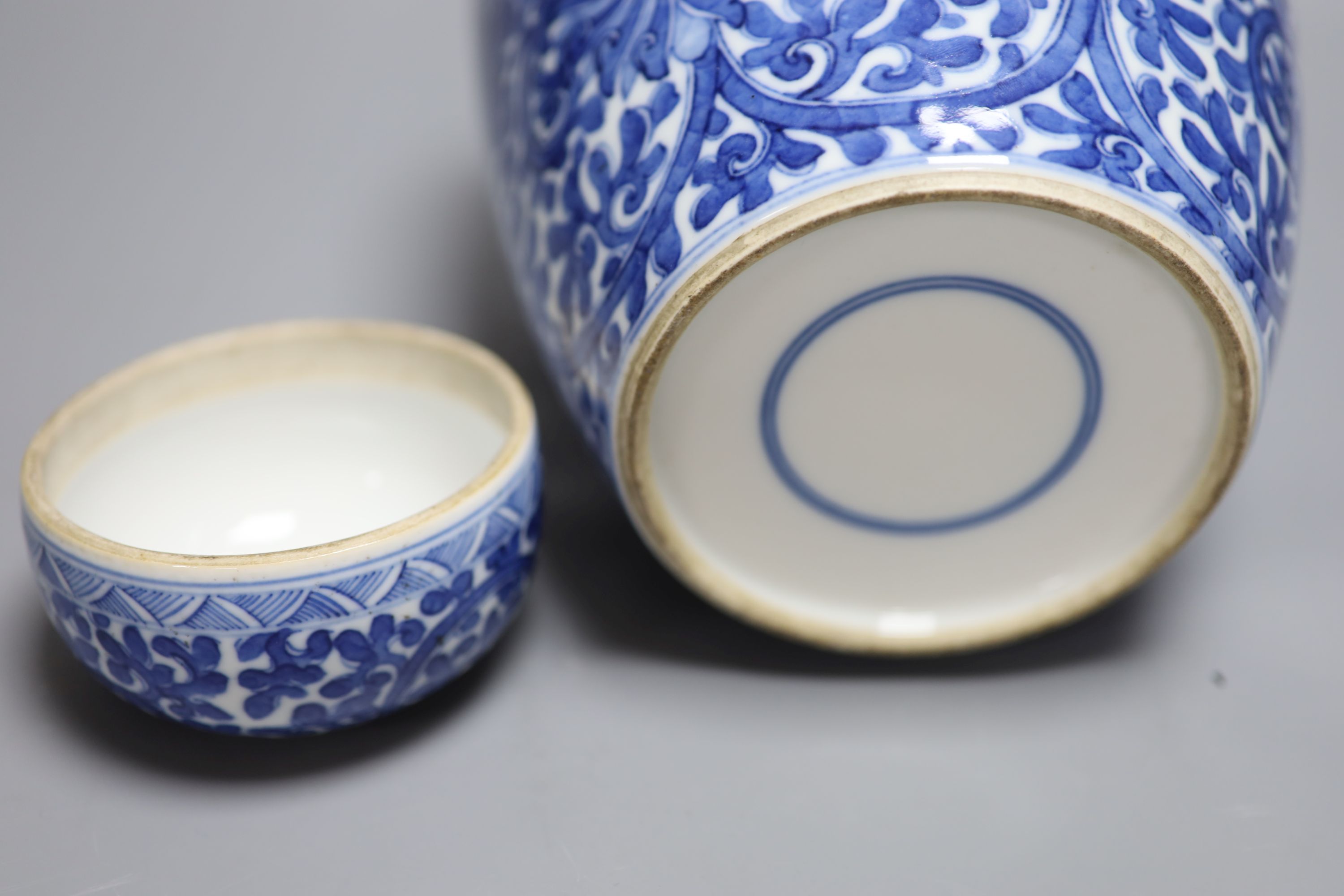 A Chinese blue and white lotus jar and cover, early 20th century, a similar dragon vase and a small Kangxi jarlet and cover, talles